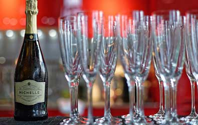 A bottle of champagne and some champagne glasses